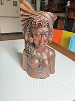 Front view of carved wooden female bust