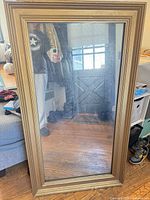 Front view of full-length mirror showing gold wood frame and overall size