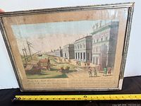 Front view of framed engraving with measuring tape