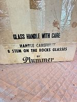 Plummer shipping box showing printed text and wear