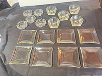 Full set arranged showing 8 square plates, 5 scalloped dishes, 5 bowls