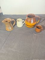 Front view of all four stoneware pieces lined up