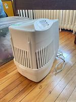 Full view of air purifier showing side vents and power cord