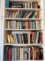 Full height of built-in bookcase with four packed shelves of books