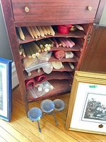 Cabinet interior showing multiple candles and 3-cup stand