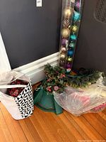 Group shot of tree stand, wreath, ornament tube and storage tote