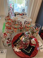 Overall lot view showing tumblers, plates, figurines