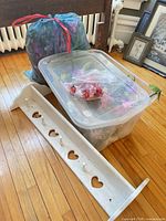 Overall lot showing tote, bag of flowers and white peg shelf