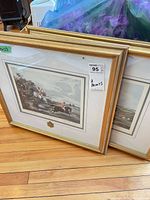 Both framed prints standing on floor showing artwork, frames and sticker noting 2 prints