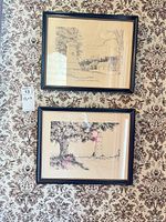 Both framed prints hanging side by side