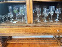 Full cabinet view showing variety of stemware