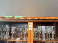 Cabinet shelf showing full assortment of glasses