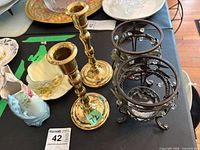 Group view of Paragon teacup & saucer, two brass candlesticks, metal warmer, blue satin glass vase