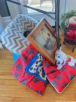 Grouped items showing framed print, nursing pillow, fleece blanket and tub