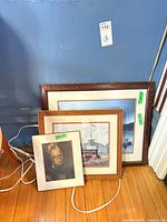 All three framed prints leaning against wall