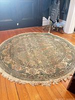Oblique view of entire round rug on hardwood floor