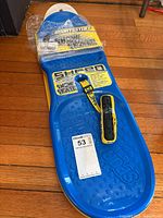 Full view of blue Sportsstuff Shred snow skate with leash and packaging