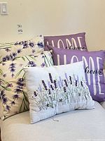 All five throw pillows grouped on sofa