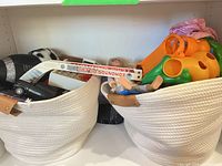 Overall view of two rope bins with assorted toys