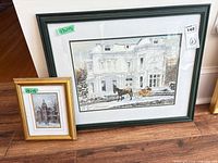 Both framed prints leaning on floor