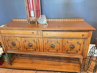 Front view showing overall buffet with drawer, three doors, dentil molding