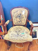 Front view of wood-framed upholstered parlour chair