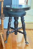 Full view of stool showing seat, legs and finish