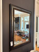 Full view of rectangular wall mirror mounted on wall