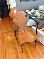 Both wooden chairs side by side showing backs and legs