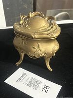 Closed view showing overall form, floral relief and feet