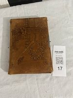 Front cover showing embossed leather design and metal clasp