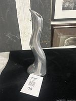 Front view of sculptural cast aluminum candlestick showing overall form and candle cup opening