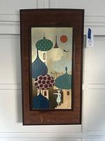 Full view of framed painting hung on wall