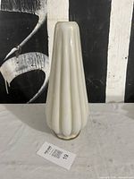 Full view of ribbed opalescent glass lamp base standing upright