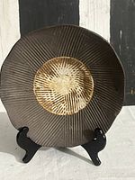 Front view showing carved texture and glazed center