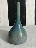 Front view of signed End of Day art glass bud vase showing swirl pattern and overall shape
