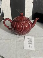 Side view of burgundy Coronado teapot with lid