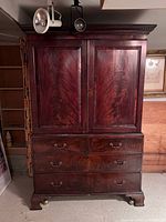 Front view showing double doors over four drawers