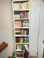 Full view of tall bookcase packed with books