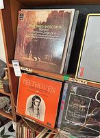 Shelf view showing Brahms Janet Baker/Previn LP, Beethoven quartet LP, partially visible Bach/Gould LP