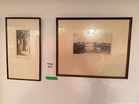 Two framed etchings on wall showing relative sizes