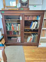 Front view of cabinet showing two glass doors and interior shelves