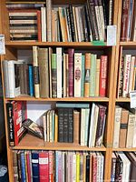 Three shelves of assorted hardcover and paperback books on furniture, antiques, Japanese art and philosophy