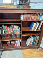 Full cabinet view showing multiple shelves of assorted hardcovers and paperbacks