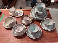 Group view of mixed teacups, saucers and plate stack