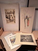 Group shot of five unframed artworks on paper