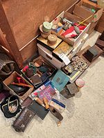 Overview of entire lot on floor showing boxes filled with vintage accessories, tools, purses and brushes