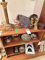 Close-up of brocade fabric adjacent to lot items