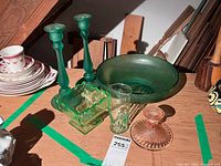 Group shot showing all six glass pieces: bowl, two tall candlesticks, compote, tumbler, small pink candlestick