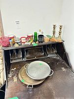 Overview of entire mixed lot on desk showing candlesticks, trays, glassware and small tins